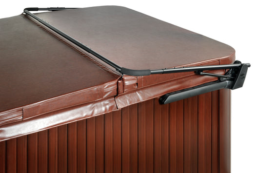 A spa cover with a tan finish and black mounting brackets, designed to fit over a spa with clearance on all sides.