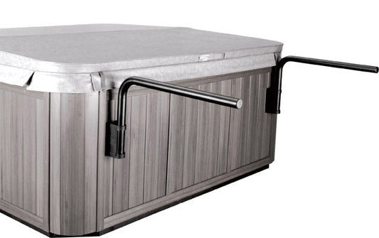 A spa cover partially placed on a spa with the CoverShelf mechanism, showing the aluminum tubing and mounting bracket.
