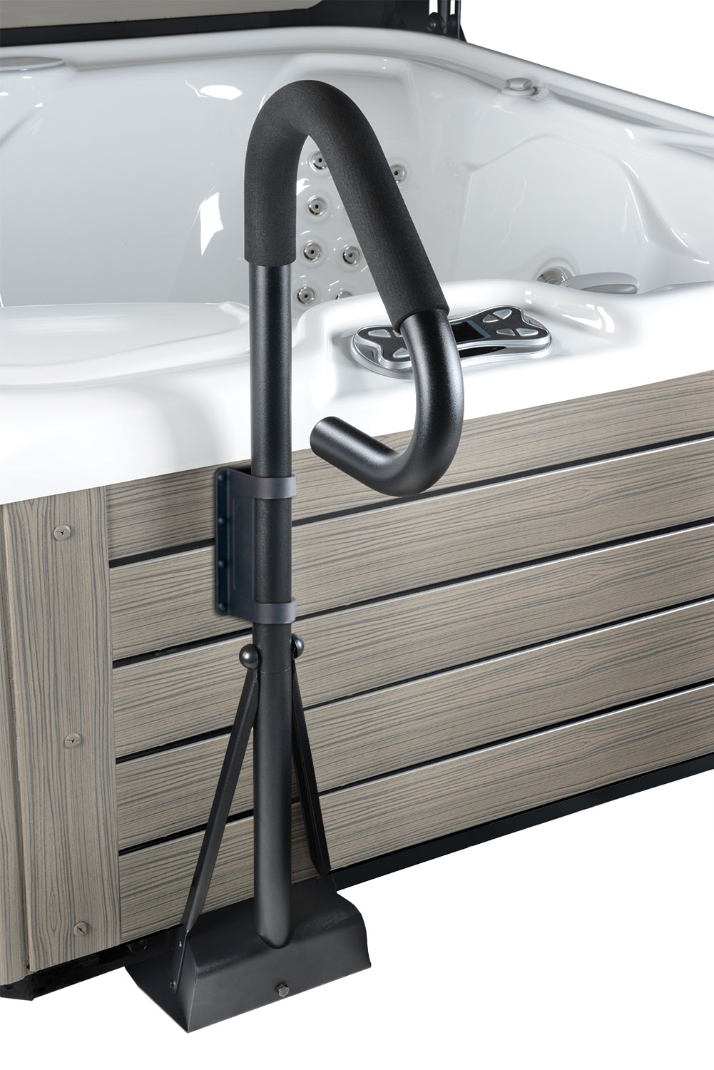 A black, metal railing with a foam grip, mounted on a wooden spa surround with a pool and spa in the background.